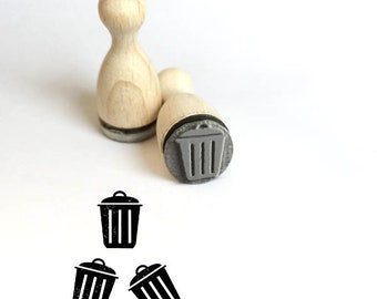 May include: Three wooden stamps with a trash can design. The stamps are mounted on wooden handles and are ready to be used for crafting or scrapbooking.