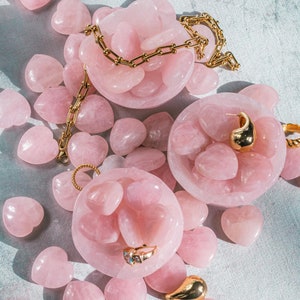Hand-carved rose quartz heart, smooth and polished, ideal as a heart-shaped palm stone or worry stone.