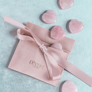 Rose quartz heart palm stone, naturally polished and hand-carved, ideal for love-themed gifts, self-care, and crystal collections.