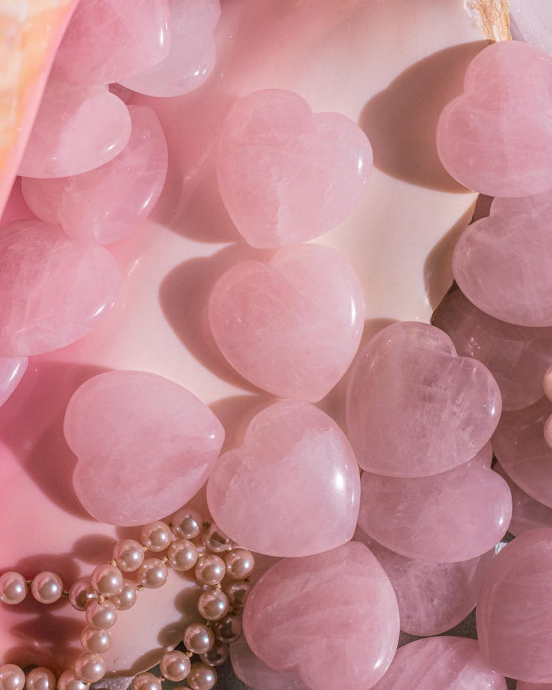 Natural rose quartz heart palm stone, hand-carved for meditation, worry stone use, or romantic gifting.