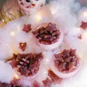 Polished strawberry quartz crystal stars displayed in pink bowls, beautiful for altar décor, meditation, or as charming gifts for crystal lovers and healers.