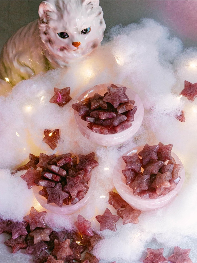 Polished strawberry quartz crystal stars displayed in pink bowls, beautiful for altar décor, meditation, or as charming gifts for crystal lovers and healers.