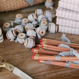 hand-dyed french blue silk ribbon on small wooden spools and pencils