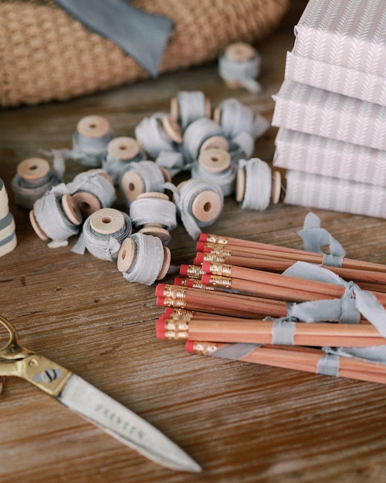 hand-dyed french blue silk ribbon on small wooden spools and pencils