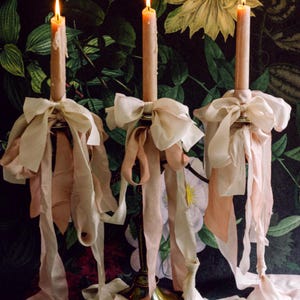 hand-dyed silk ribbon tied around a candelabra in bows
