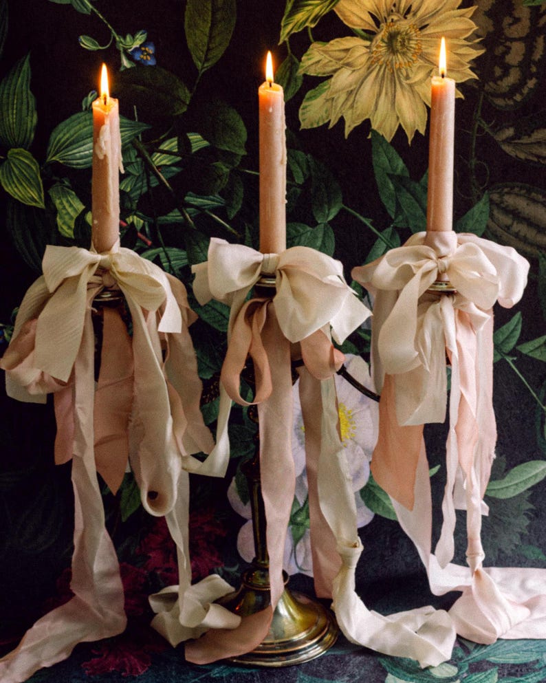 hand-dyed silk ribbon tied around a candelabra in bows