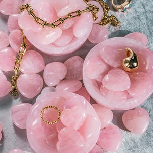 Pink-toned rose quartz bowl, hand-carved for holding jewelry, small keepsakes, or decorative accents.