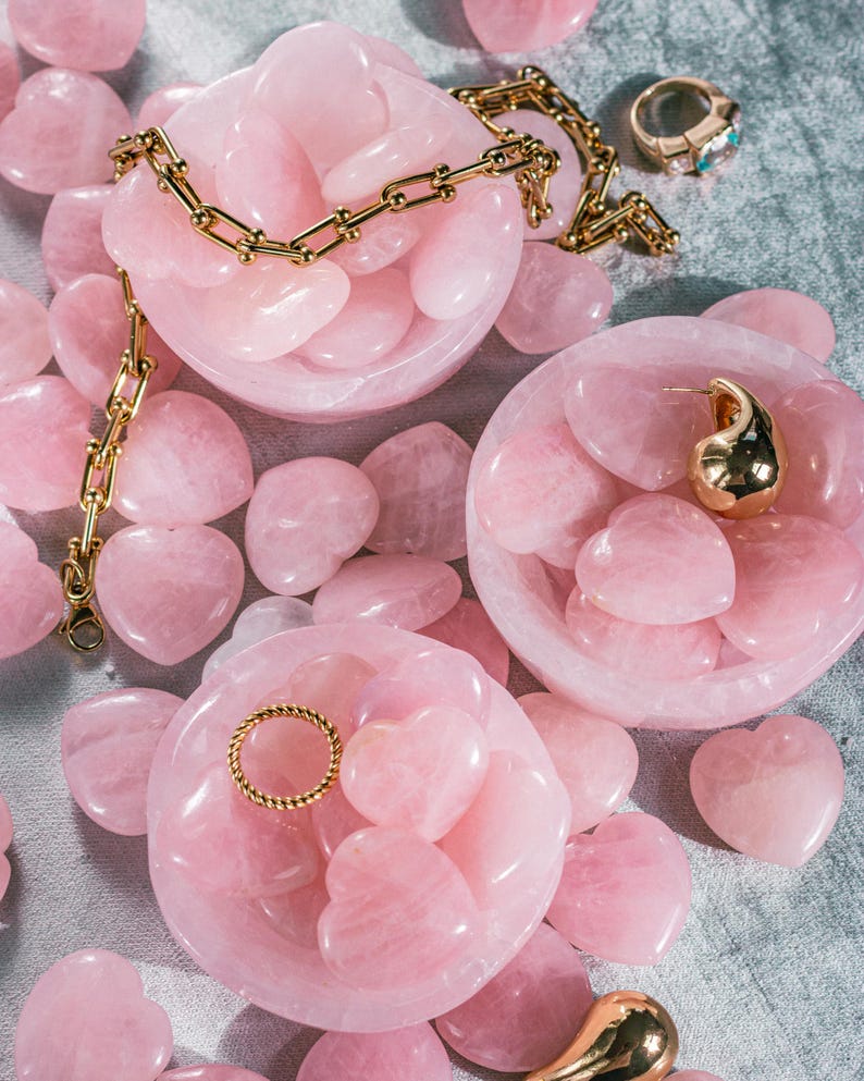 Pink-toned rose quartz bowl, hand-carved for holding jewelry, small keepsakes, or decorative accents.