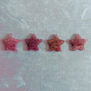 Hand-polished strawberry quartz stars in warm pink tones, ideal for spiritual healing, meditation spaces, or as meaningful gifts that inspire love and positivity.