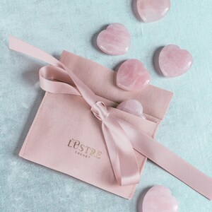 Hand-carved natural rose quartz heart palm stone polished and perfect as a worry stone or meditation tool.