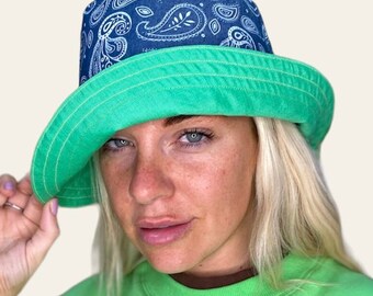 Reversible green linen bucket hat with wide brim and chambray denim paisley designs.