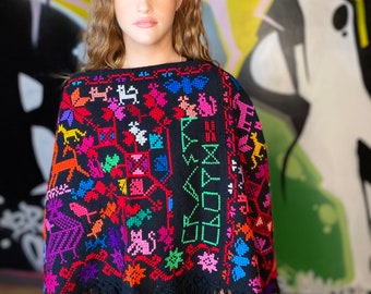 Embroidered poncho with tassels.