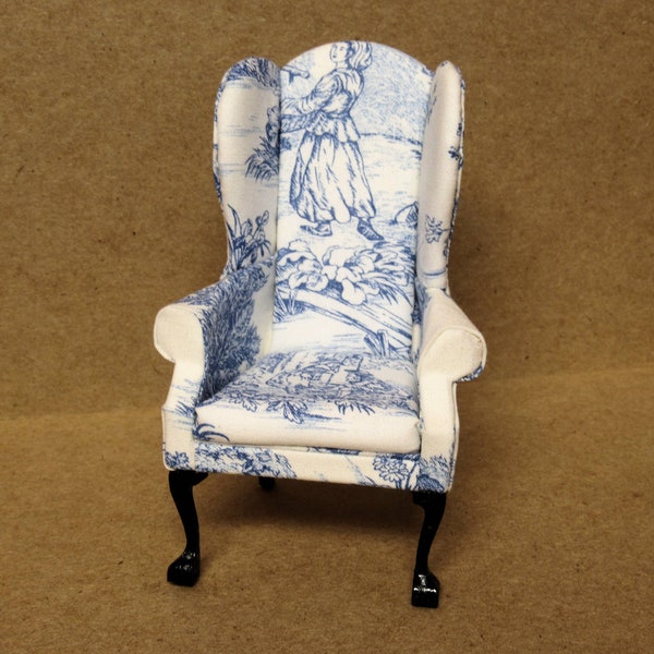Queen Anne style wingback chair, blue French toile upholstery. Black legs. 1:12 scale miniature. Artisan handmade USA.