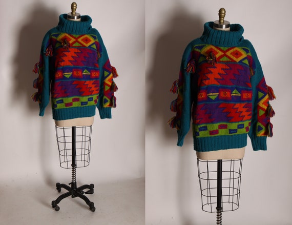 1980s Green Multi-Colored Aztec Abstract Geometric Long Sleeved Hand Knit Fringe Pom Pom Pullover Sweater by Catharine Lover -M