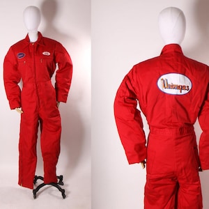 May include: Red insulated coveralls with a Uniroyal logo on the back. The coveralls have a zipper closure and two pockets on the front.