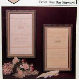 May include: A framed cross-stitch pattern with the text "From This Day Forward" and a heart with a stylized wedding dress design. The pattern is part of the "HeartStrings" collection by "The Artists Collection" and is presented by "Pat Thode".