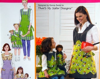 May include: A sewing pattern for a green, black, and white apron with a chicken print. The pattern is for sizes A, and includes instructions for making a matching apron for a doll. The pattern is from Simplicity and is designed by Donna Zwicki for That's My Sister Designs.