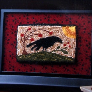 May include: A book titled "Miniature Punchneedle Embroidery: Simple Techniques, Beautiful Projects" by Linda Repasky. The cover features a framed punchneedle embroidery of a black crow on a branch with red berries, a yellow sun, and green foliage against a red background.