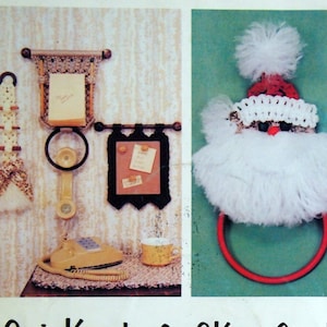 May include: A collection of colorful, handmade macrame projects, including a Santa Claus head, a towel rack, a toothbrush holder, a wall hanging with a bird, a flower pot holder, a snowman-shaped tote bag, a butterfly-shaped towel rack, and a purse. The projects are made with colorful yarn and cord and are labeled "QuickKnot & SKrapCord Projects Included".