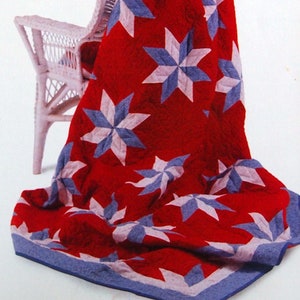 May include: Quiltsmart Eight Point Star quilting pattern book with a red, white, and blue quilt on a white wicker chair. The book includes instructions for a Hunter Star and Table Runner.