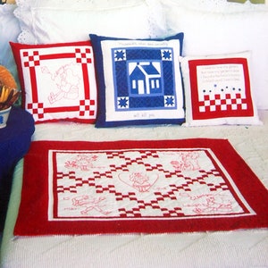 May include: A book titled "Fun with "Mama Said"" with a red, white, and blue quilt on a bed. The book cover features the title in yellow letters on a red background. The quilt is made with red and white squares and features a heart in the center. The book is about quilting tips and techniques.