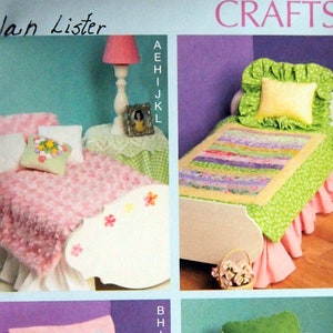 May include: A sewing pattern for a doll bed with four different designs. The pattern is from McCall's Crafts and is for size OSZ. The designs include a pink and green patchwork quilt, a pink and green floral quilt, a green and white patchwork quilt, and a green and white floral quilt.