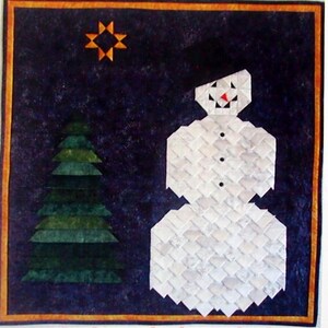 May include: A patchwork quilt titled "Frosty" featuring a snowman, Christmas tree, and star on a dark blue background. The quilt measures 30 x 30 inches.