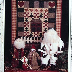 May include: A book cover titled "The Christmas House" featuring a quilt with hearts and stars, and three Christmas figures. The figures include a Santa Claus doll, a snowman doll, and another Santa Claus doll. The background has a floral pattern.