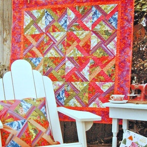 May include: A quilt pattern book with the title "Give it a Whirl" featuring a colorful quilt with a geometric design. The book includes instructions for making a quilt with a similar design.