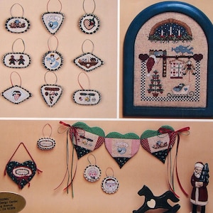 May include: A cross-stitch pattern booklet titled HeartStrings A Cranberry Christmas featuring various holiday-themed ornaments, a framed sampler, a heart-shaped garland, a small black rocking horse, and a Santa Claus figurine on the cover.