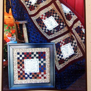 May include: A framed quilt block with a checkered pattern in red, blue, and brown. The block is surrounded by a white border and a dark brown frame. The text "To many things there is a season, a time to every purpose under the heaven." is embroidered in the center of the block. The quilt block is titled "Lavender Season" and is made using the double stitch.