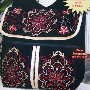 May include: Black messenger bag with embroidered floral design in red and gold. The bag has a flap closure and a front pocket. Dimensions are 22.86cm x 22.86cm x 8.89cm. The text on the bag says "the gadabout".