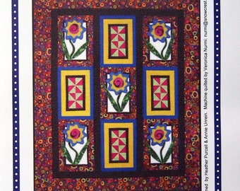 May include: A quilting pattern for a wall hanging or throw featuring a colorful floral design with the title "Bling Bling Blooms". The pattern is designed by Heather Purcell & Annie Unrein and machine quilted by Veronica Nurmi. The pattern includes instructions for making a 48" x 56" throw or a 13 1/2" x 17 1/2" wall hanging.