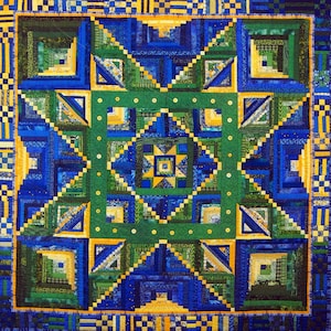 May include: Book cover with the title "Log Cabin Quilts" by Rita Weiss & Linda Causee. The cover features a colorful quilt with a geometric pattern in shades of blue, green, and yellow.
