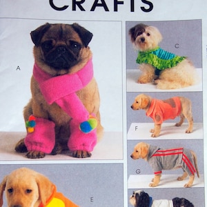 May include: A sewing pattern for dog clothes, McCall's Crafts M5776 Size OSZ. The pattern includes instructions for making a variety of dog clothes, including a scarf, a vest, a sweater, and a coat. The pattern is illustrated with photos of dogs wearing the finished garments.