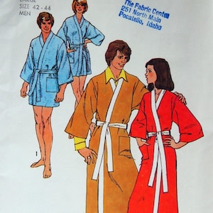 May include: A Simplicity 5685 sewing pattern envelope featuring illustrations of bathrobes. The designs include a short blue robe, a knee-length mustard yellow robe with a white trim and belt, and a floor-length red robe with a white trim and belt.