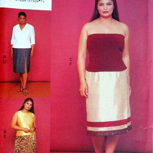 May include: Vogue Patterns Mode Magazine Collection. The image shows a woman wearing a burgundy strapless top and a cream-colored skirt with a red border. The image also shows other clothing options. The text on the image reads "7261" and "26W-28W-30W".