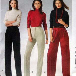 May include: A McCall's M5239 sewing pattern envelope for pants in sizes 8-10-12-14. The cover features three variations of trousers: black straight-leg pants, light beige tailored pants, and wide-leg red pants, each paired with a long-sleeved turtleneck.