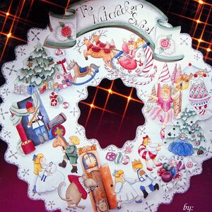 May include: A book cover titled Expressions of... A Fantasy Christmas and The Nutcracker Sweet by Janet Riegel & Patti Daugherty. The cover features a circular, white, lace-edged illustration of holiday scenes, including a sleigh, a nutcracker, and a clock, set against a dark background with a glowing orange grid pattern.
