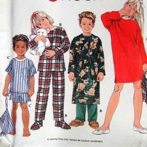 May include: Simplicity sewing pattern 7407 featuring children's sleepwear designs. The pattern includes options for pajamas, a robe, and a nightgown. The image shows illustrations of the finished garments in various styles and colors.