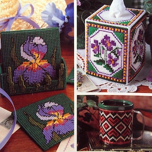 May include: A magazine cover titled "Plastic Canvas" with a green and white title. The cover features various plastic canvas projects, including a tissue box, coasters, and a mug, all with floral designs. The magazine is dated May 1993.
