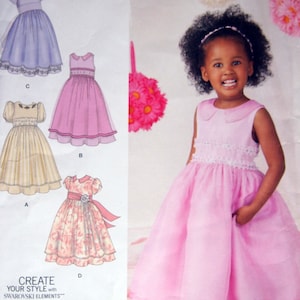 Puede incluir: Un patrón de costura para un vestido de niña. El patrón incluye cuatro estilos diferentes: un vestido azul claro con ribete de encaje, un vestido rosa con cuello Peter Pan, un vestido amarillo con falda con volantes y un vestido de estampado floral con una cinta. El patrón es para las tallas 1/2-3. El patrón es de Simplicity y el número de patrón es 1507.