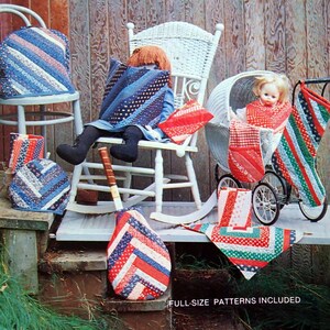 May include: A book cover with the title "Sew Easy Strip Quilting" by Nancy Martin. The cover features a doll sitting in a rocking chair, a doll in a stroller, and various quilted items in red, white, and blue.