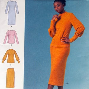 May include: Simplicity sewing pattern S8982, featuring a woman in an orange knit outfit. The pattern includes options for a dress, top, and skirt. The text "easy-to-sew" is visible. Size U.S. 14-22.