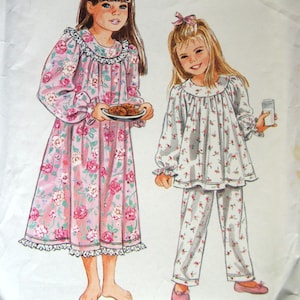 May include: A white ceramic mug with a black handle and the text "But First, Coffee" in a handwritten style. The mug is on a white surface. The mug is approximately 4 inches tall.