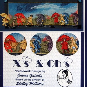 May include: Needlework design titled "Slicker Parade" featuring a colorful illustration of children with umbrellas. The design includes the text "X's & Oh's" and is based on the artwork of Shelley McVittie.