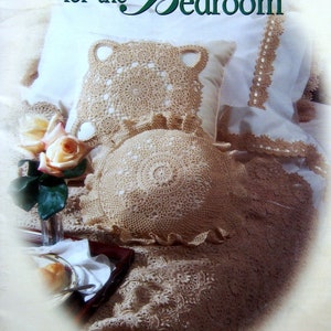 May include: A book titled "Heirloom Crochet for the Bedroom" featuring 23 crochet designs by Patricia Kristoffersen. The cover shows a close-up of crocheted pillows and a throw blanket in a cream colour.