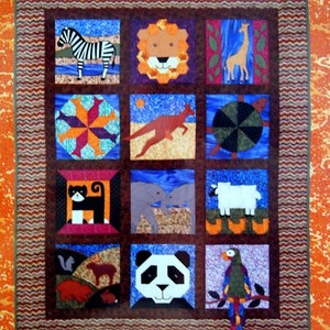 May include: A book titled "Quilted Safari: A Menagerie of Patchwork and Appliqué" by Donna Wilder. The cover features a colourful patchwork quilt with various animal designs, including a zebra, lion, giraffe, kangaroo, cat, elephant, sheep, squirrel, panda, and parrot.