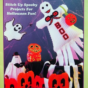 May include: A craft book cover with the words "HAPPY Halloween!" in green and yellow. The cover features stitched Halloween projects, including ghosts, pumpkins, and a mummy-like figure. Text reads "Stitch Up Spooky Projects For Halloween Fun!" and "7 Easy-to-Stitch Halloween Projects."