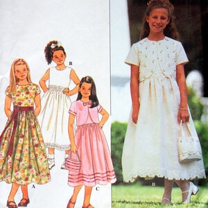 May include: Simplicity sewing pattern 8546 size AA for children's dresses. The envelope features illustrations of three dress variations: a floral print dress with a sash, a white dress with a bolero jacket, and a pink dress with a matching bolero jacket.